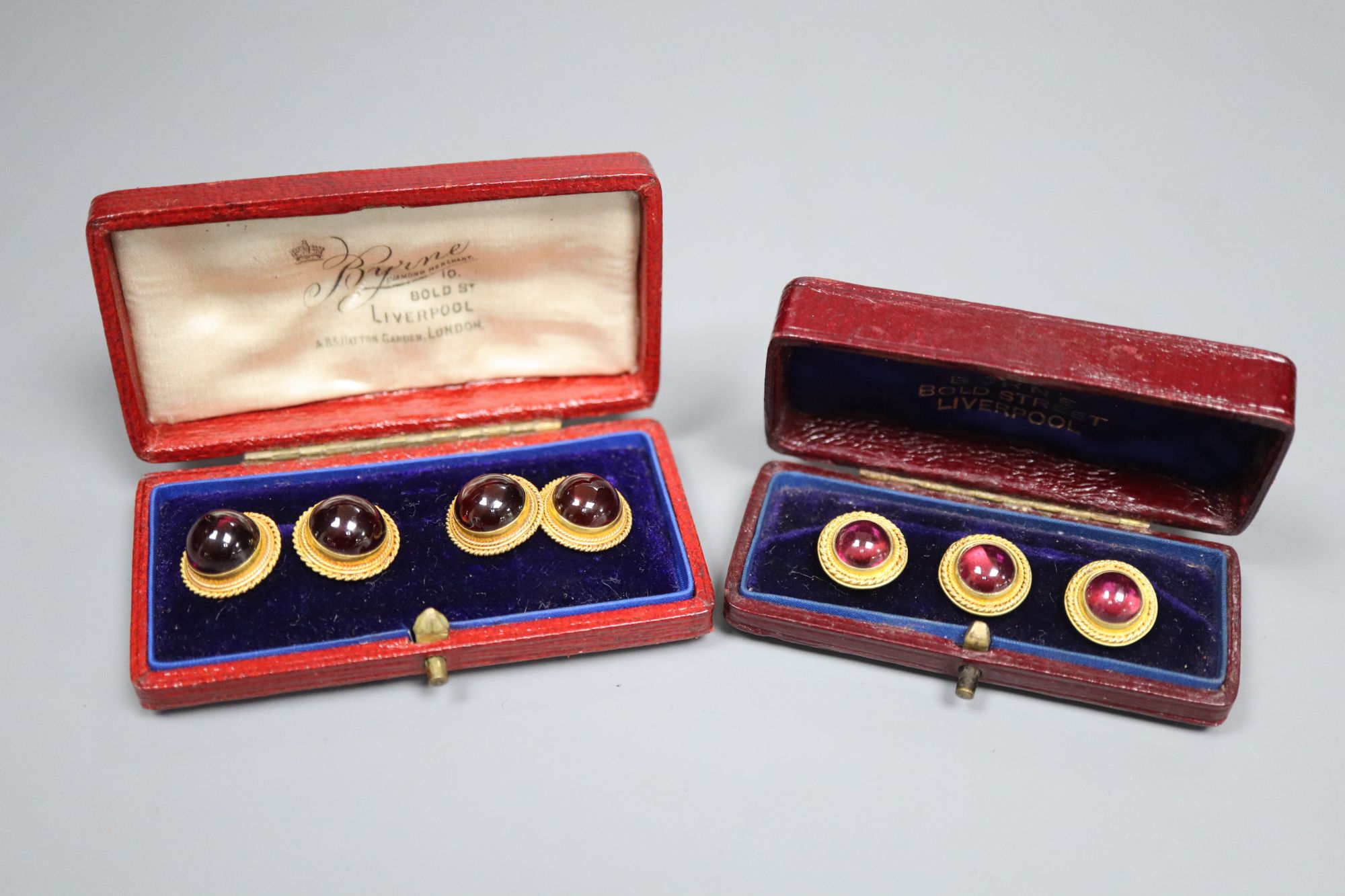 A pair of Victorian yellow metal and red cabochon cufflinks, gross 8.4 grams, and a matching set of three dress studs, gross 4.8 grams,